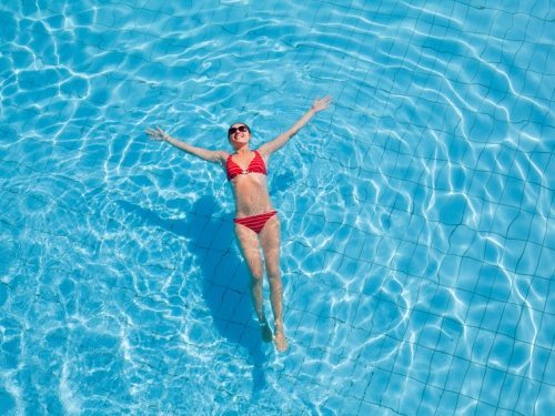 Young woman relaxing in the swimming pool